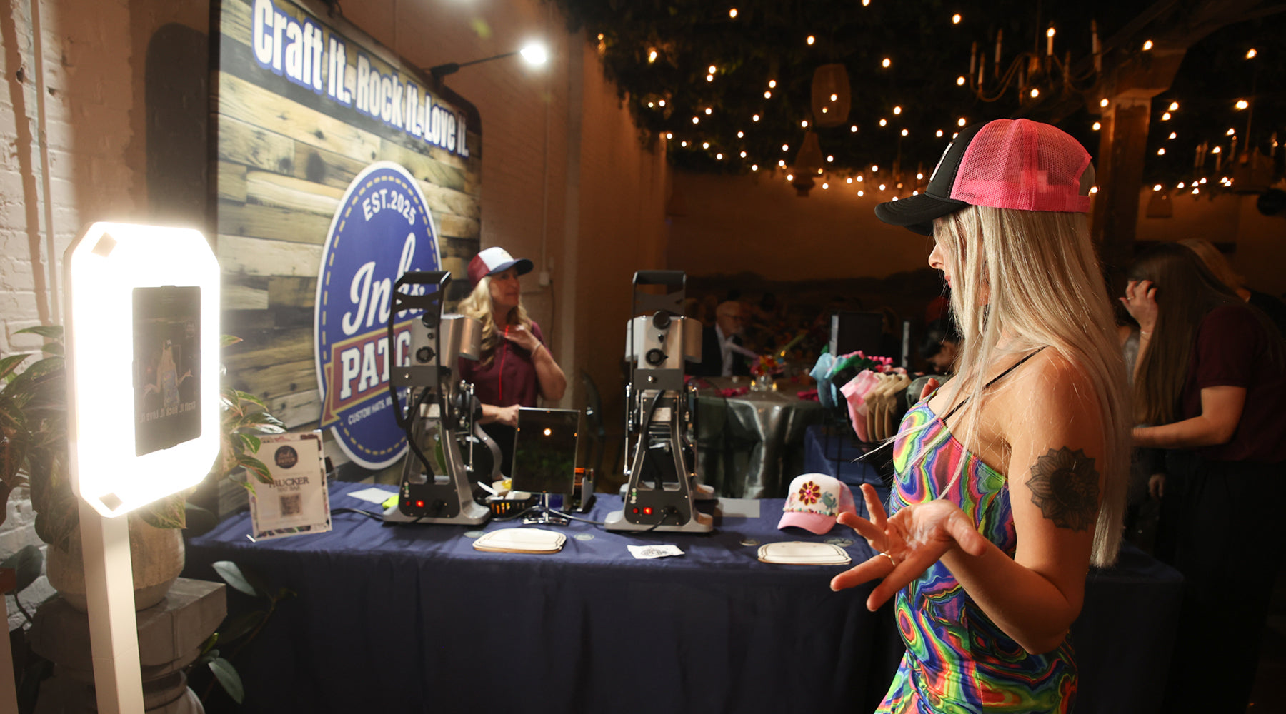 Snapping a photo at the photo booth after creating a custom hat.